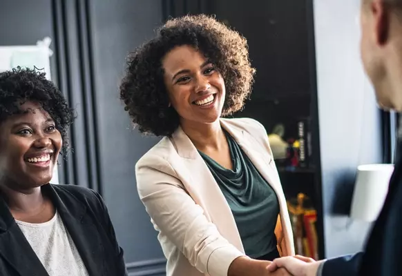 business woman shaking hands representing how to track affilliate sales
